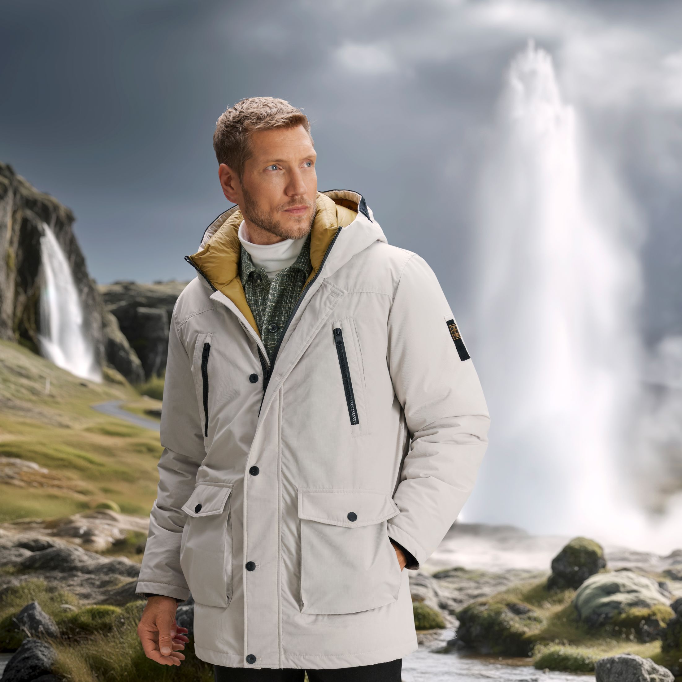 Model trägt weiße Winterjacke in Landschaft vor einem Geysir